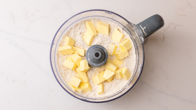butter cubes and flour in food processor