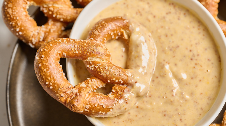 pretzel covered in honey mustard sauce