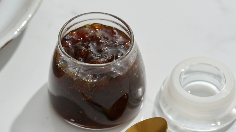 jar full of onion jam on a table