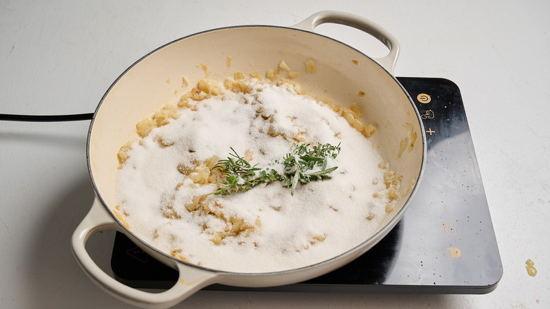 dissolving sugar into onions in a skillet