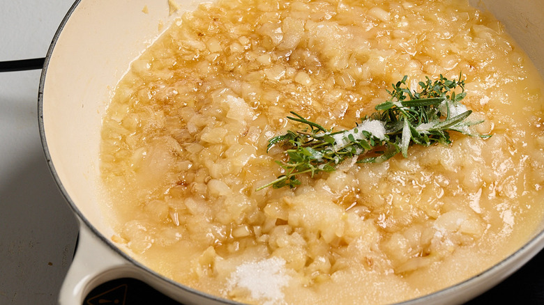 sugar dissolving in a skillet over onions