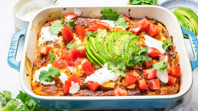 Easy tortilla breakfast casserole with toppings all around.