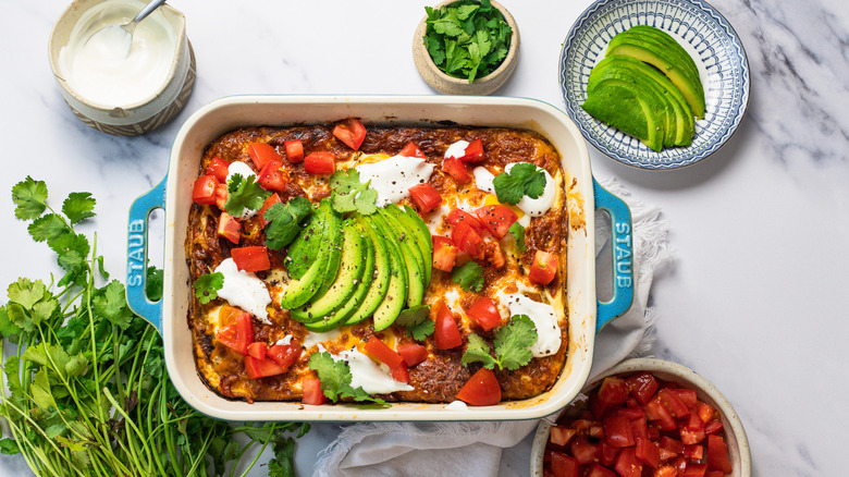 Easy tortilla breakfast casserole with toppings all around.