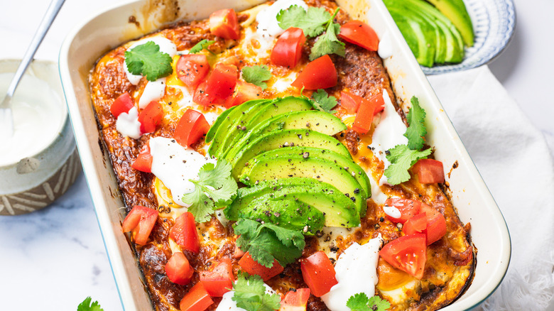 Easy tortilla breakfast casserole with toppings all around.