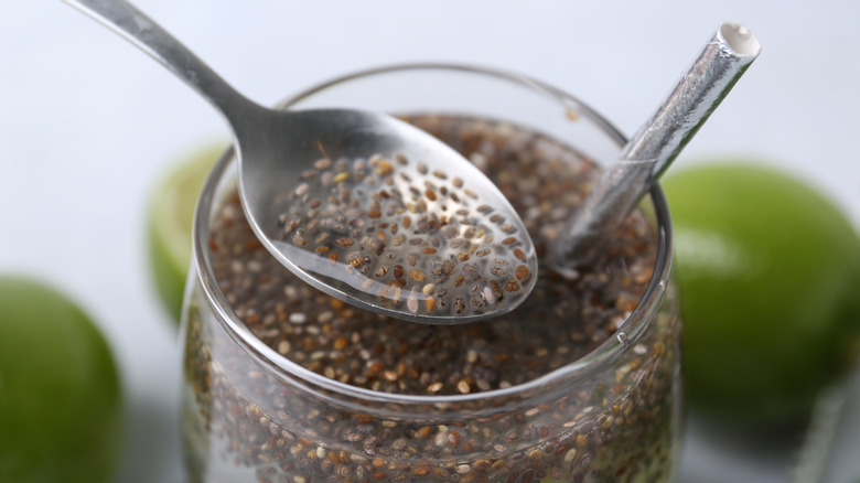 Glass of soaked chia seeds in a glass with a straw