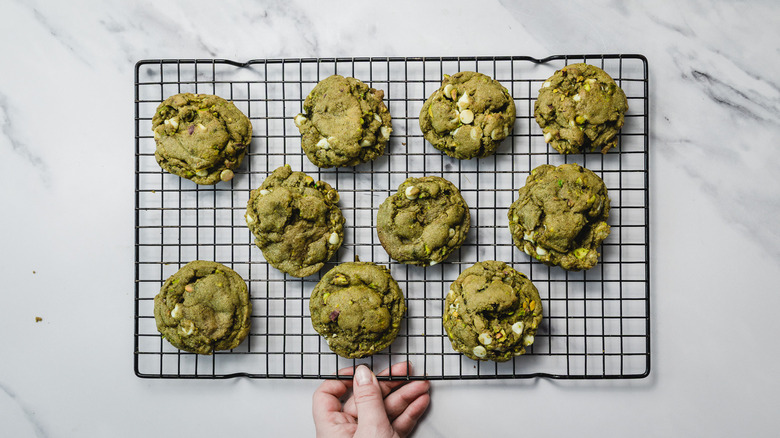 White chocolate matcha cookies on cookie drying rack