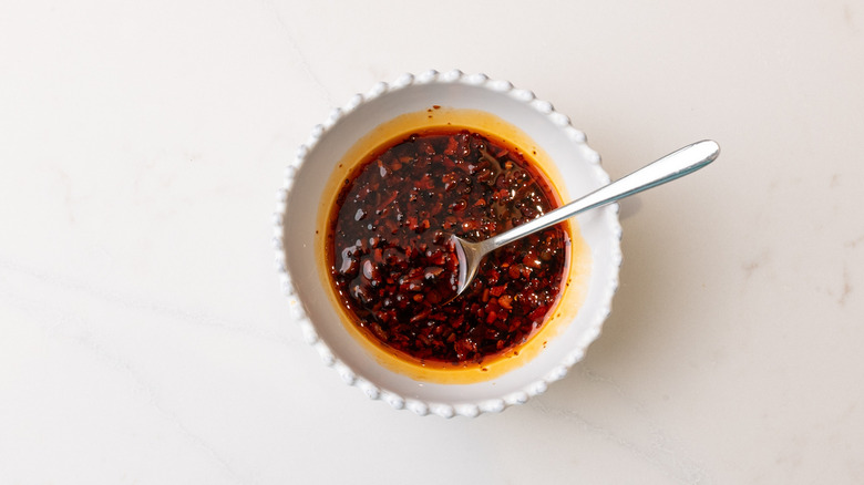 spicy soy dipping sauce in bowl with spoon