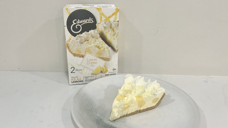 Edwards lemon crème pie slice on a plate in front of the package