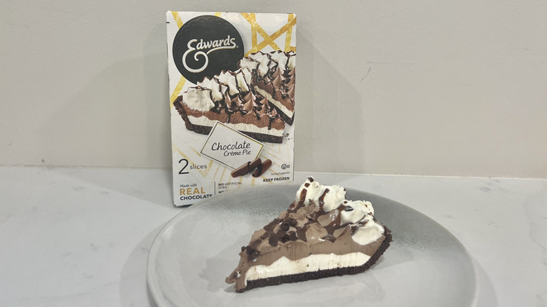 Edwards chocolate crème pie slice on a plate in front of the package