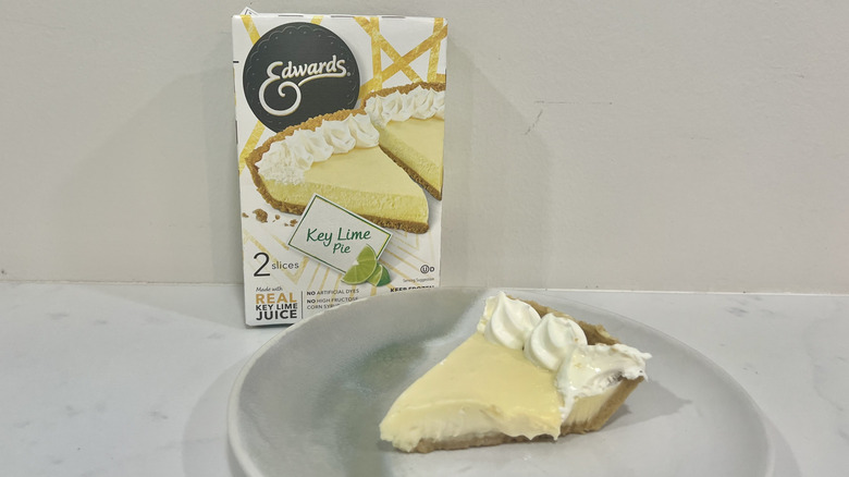 Edwards Key lime pie slice on a plate in front of the package