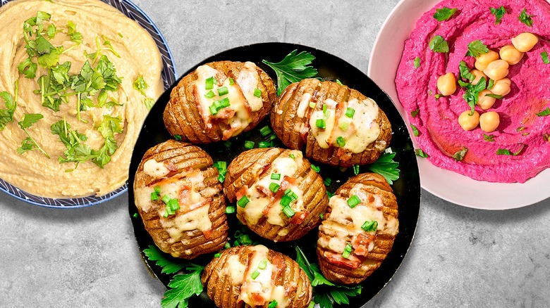 baked potatoes and bowls of hummus
