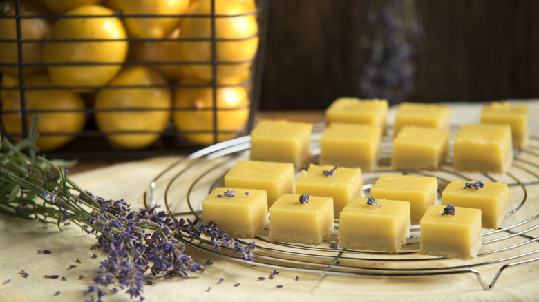 Lemon bars on a wire rack with lavender