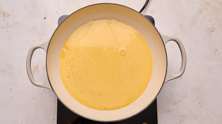 Uncooked egg mixture in skillet