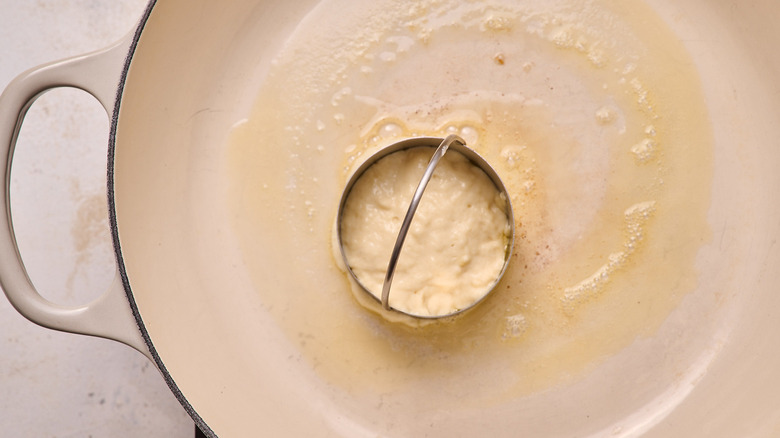 batter poured into a mold in buttered pan