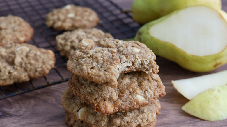 oatmeal cookies stacked next to pear slices