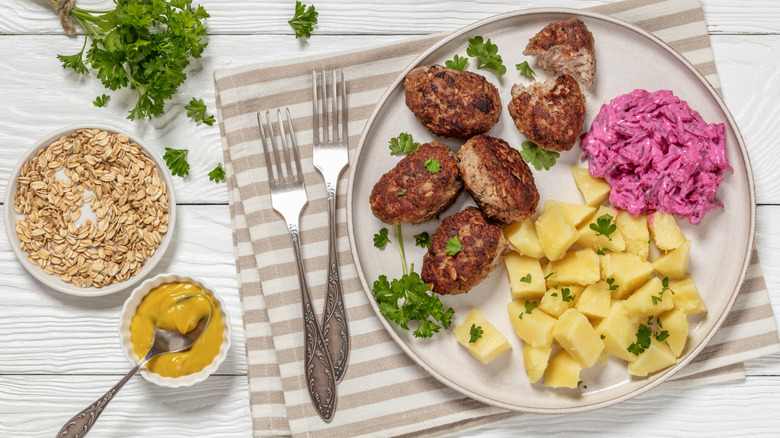 A plate of Danish meatballs, boiled potatoes, and pickled beets