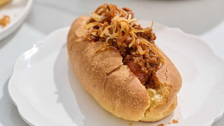 chili dog in a cornbread bun on a plate