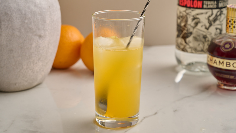 stirring cocktail in a glass with ice