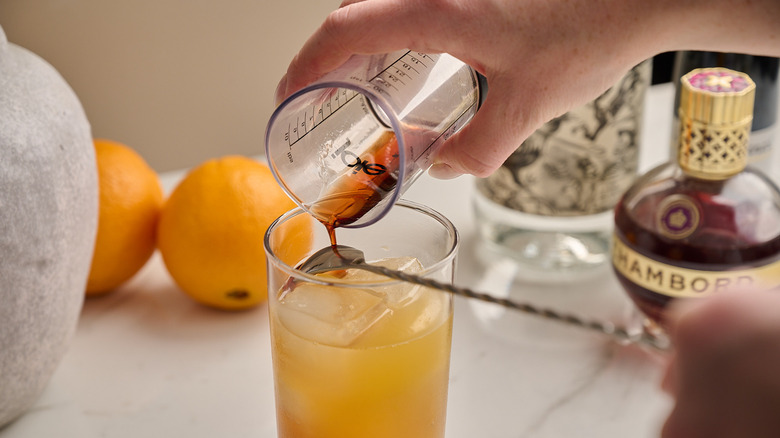pouring creme de cassis over spoon