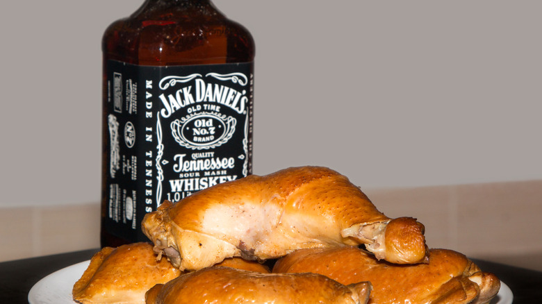 bottle of Jack daniel's and a plate of chicken
