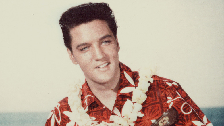 Elvis Presley in Hawaiian shirt with guitar