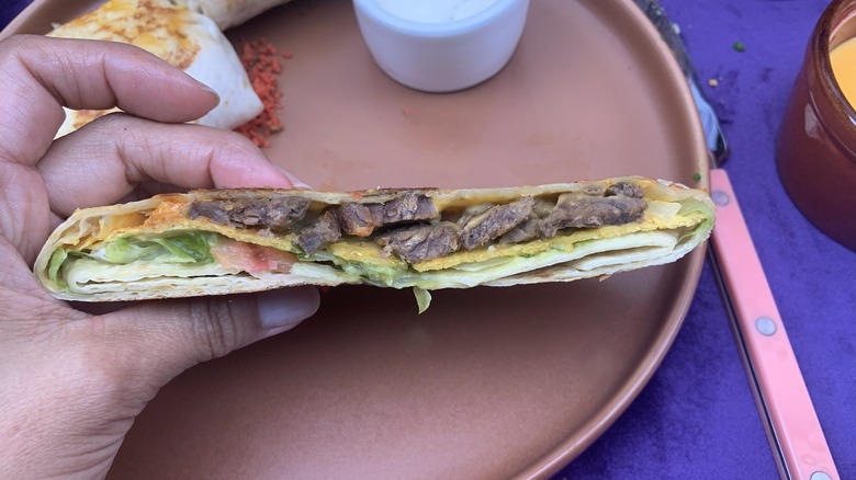 hand holding a Brock's California Crunchwrap half