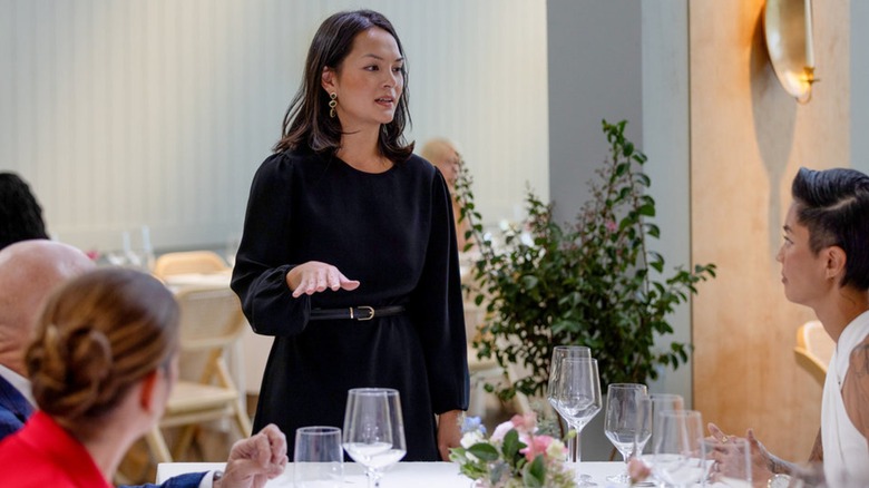 Duyen Ha addressing Kristen Kish and others sitting at a table