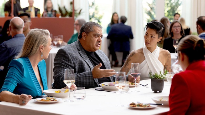Clare Reichenbach, Michael Mina, and Kristen Kish sitting at a restaurant table talking