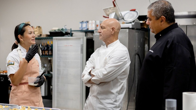 Duyen Ha, Tom Colicchio, and Michael Mina standing in a kitchen and talking