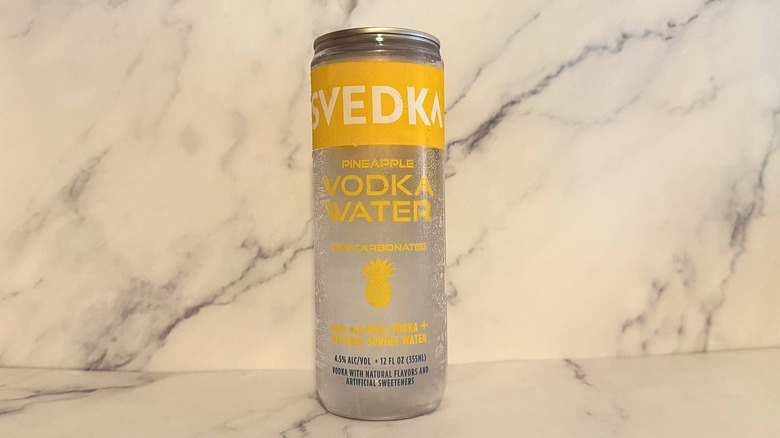Can of Svedka Pineapple Vodka Water on marble surface