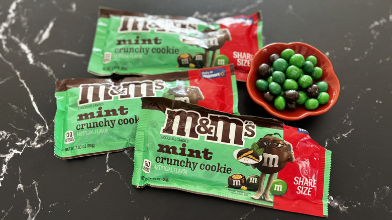 M&M's Mint Crunchy Cookie candy packages with M&M's in bowl