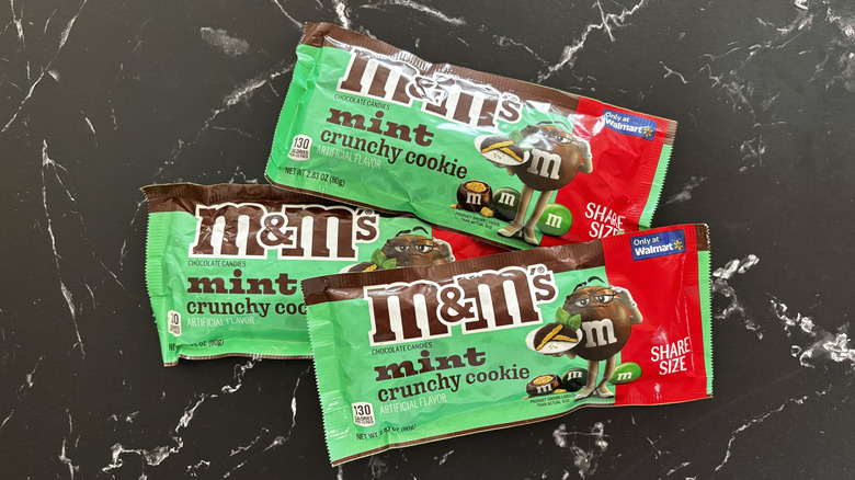 Three M&M's Mint Crunchy Cookie candy packages on countertop