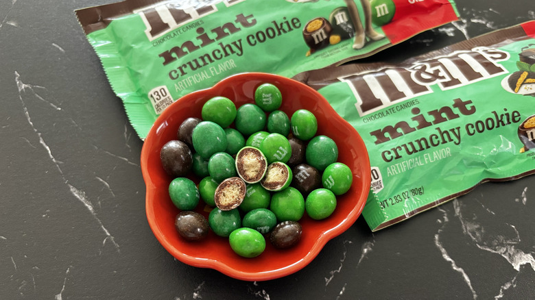 M&M's candy in bowl with packages in the background