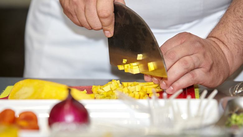 Close-up of chef prepping produce