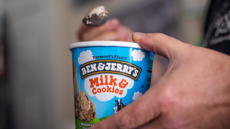Person holding a pint of Ben & Jerry's ice cream