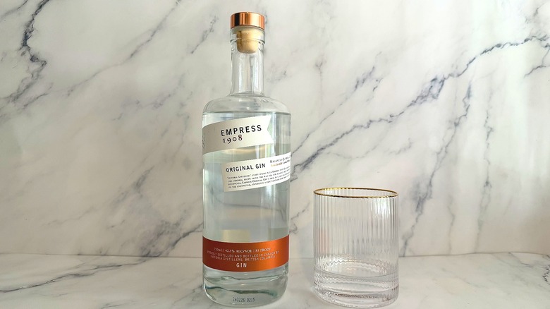 Bottle of Empress 1908 Original Gin next to a glass of gin