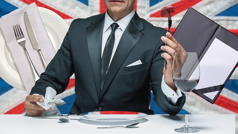 Person eating at a fine-dining restaurant with Union Jack in the background
