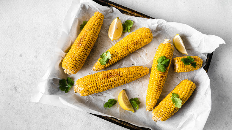 Corn with lemon wedges