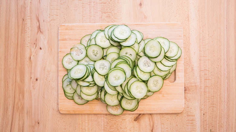 sliced cucumbers on cutting board