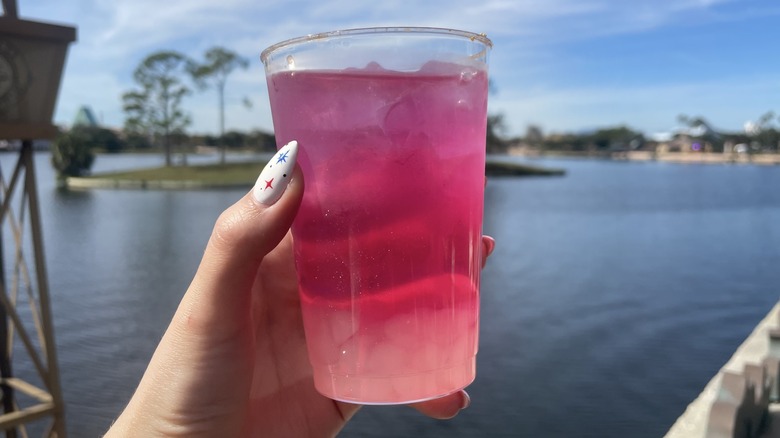 Purple drink in front of water