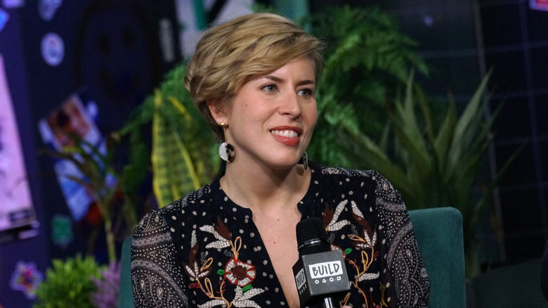 Erin Napier holding a microphone onstage at Build Series