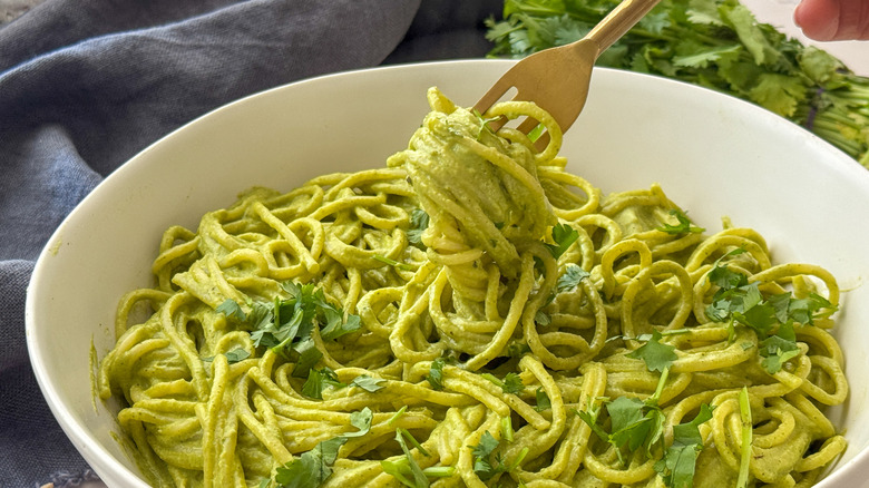 fork with pasta in bowl