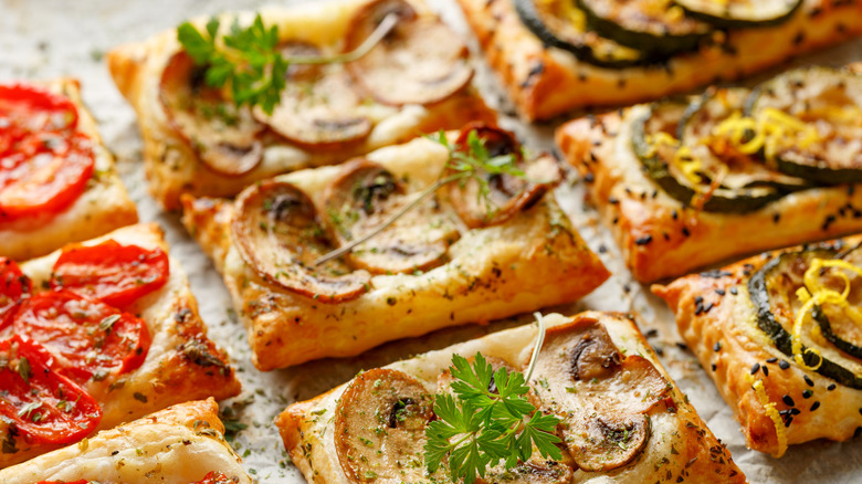 Puff pastry flatbreads with toppings and herbs