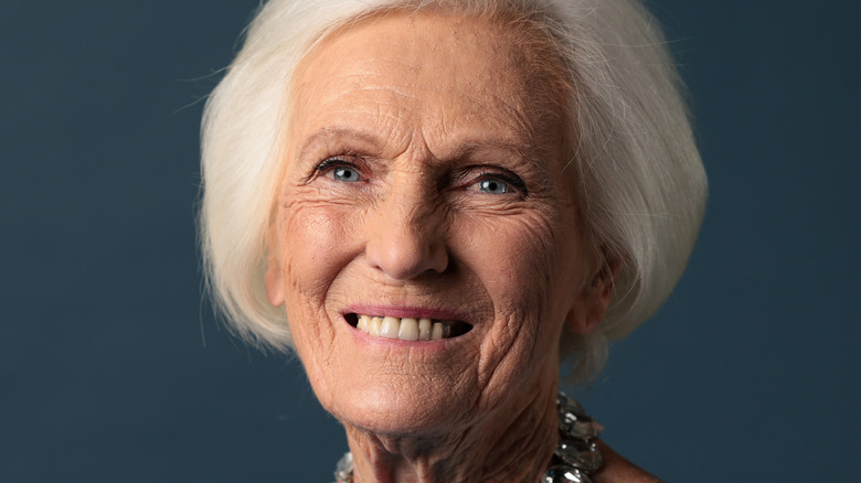Mary Berry headshot on blue background