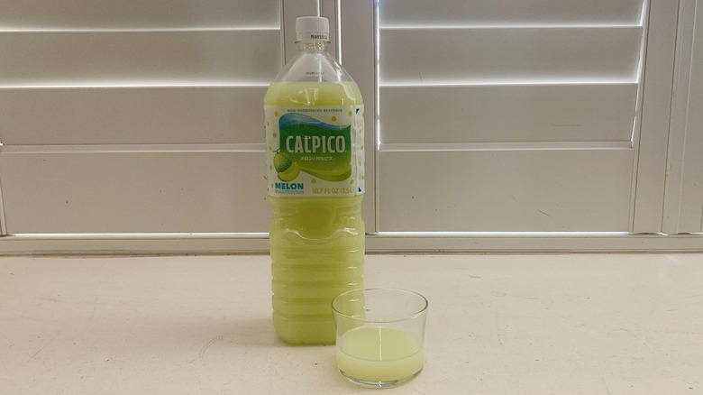 bottle of Calpico Melon beside a half-filled glass