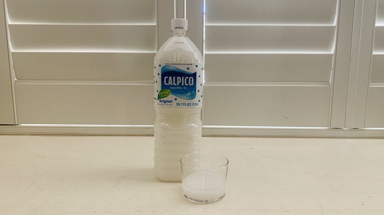 bottle of Calpico Original beside a half-filled glass