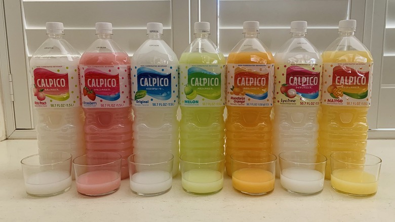 row of Calpico bottles beside half-filled glasses