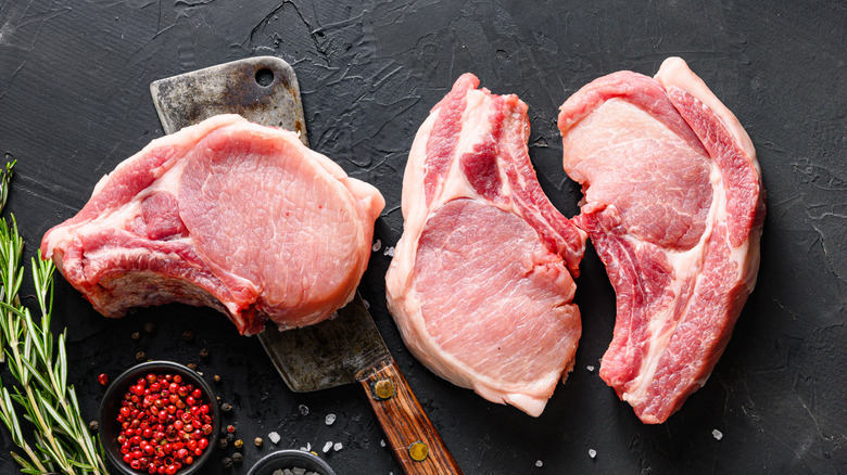 three raw pork chops