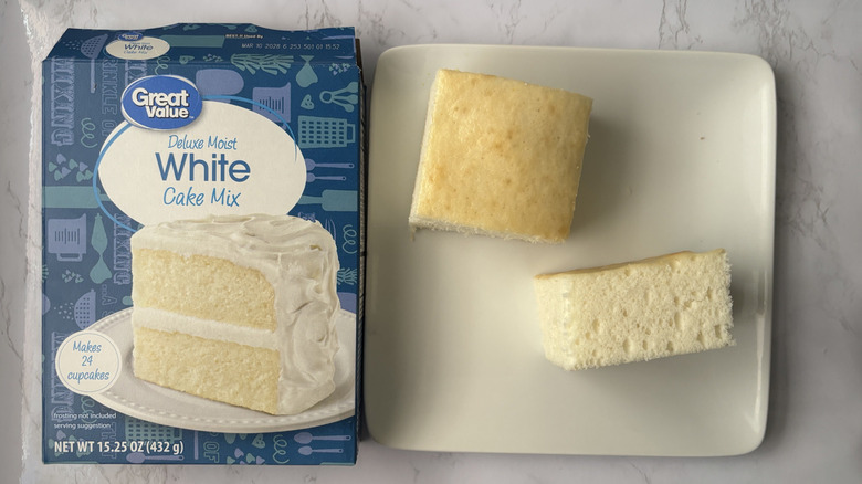 Two pieces Great Value white cake on plate next to box of white cake mix