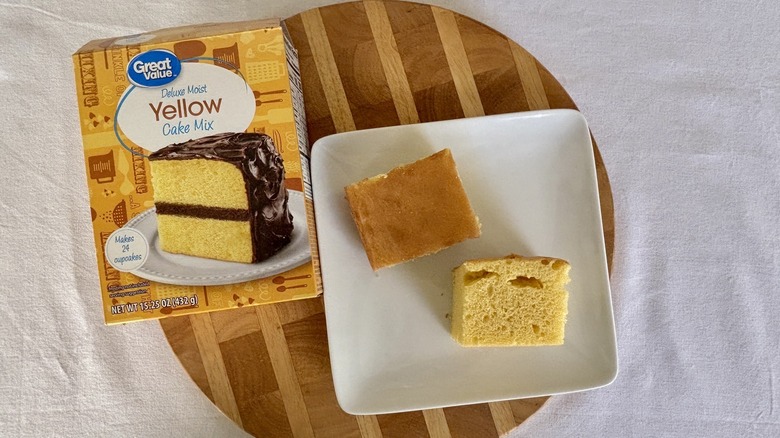 Two pieces Great Value yellow cake on plate next to box of yellow cake mix